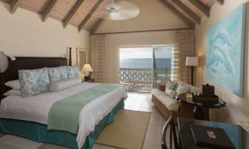 a bedroom with a bed and desk in a hotel room