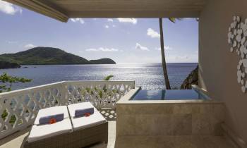 a view of a bedroom next to a body of water