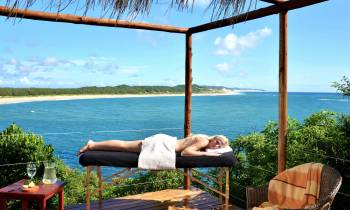 a chair sitting in front of a body of water