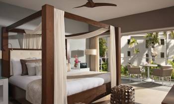 a bedroom with a bed and desk in a room