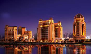a large body of water with a city in the background