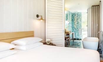 a bedroom with a bed and desk in a room