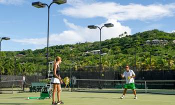 a group of people on a court with a racket