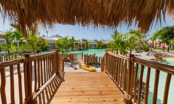 a row of wooden benches sitting next to a body of water