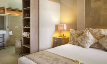 a bedroom with a bed and a mirror