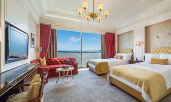 a bedroom with a bed and desk in a room