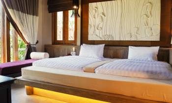 a bedroom with a bed and desk in a room