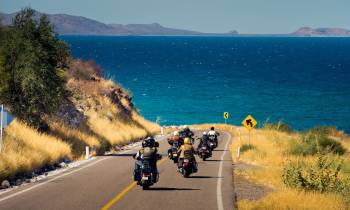 a person riding a motorcycle on the side of a road