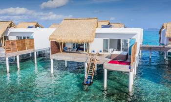 a group of lawn chairs sitting next to a pool of water