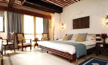 a bedroom with a large bed in a hotel room