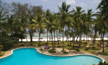 a group of palm trees next to a swimming pool