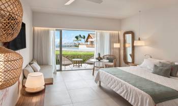 a bedroom with a bed and a chair in a room