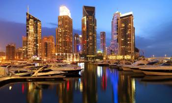 a large body of water with a city in the background