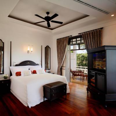a bedroom with a bed and desk in a room