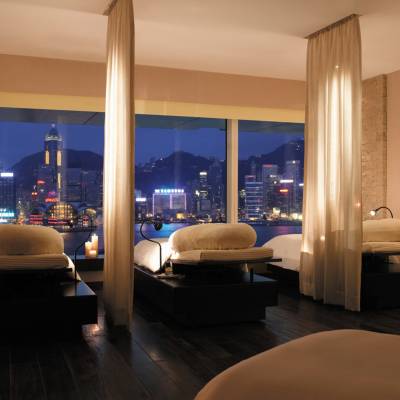 a hotel room with a bed and looking at the camera
