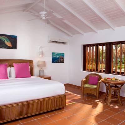 a bedroom with a bed and a chair in a room