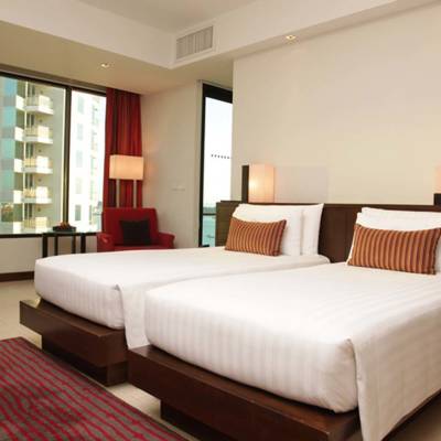 a bedroom with a bed and desk in a hotel room