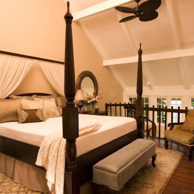 a bedroom with a bed and desk in a room