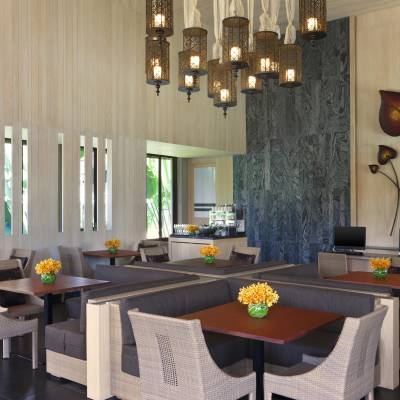 a room filled with furniture and vase of flowers on a table