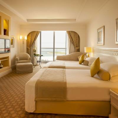 a bedroom with a bed and a mirror in a room