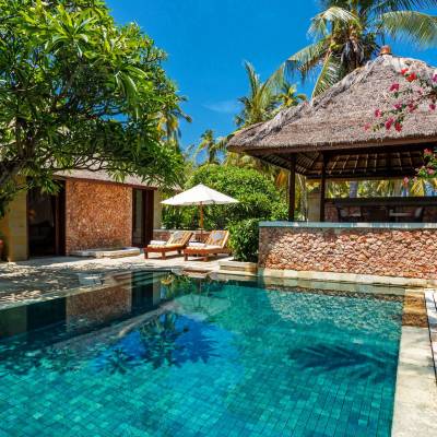 a house with a pool outside of a building