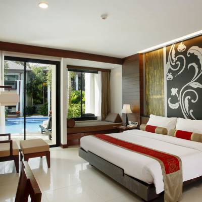 a bedroom with a bed and desk in a room