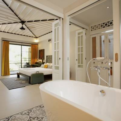 a large white tub sitting next to a window