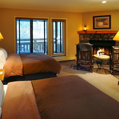 a hotel room with a bed and looking at the camera