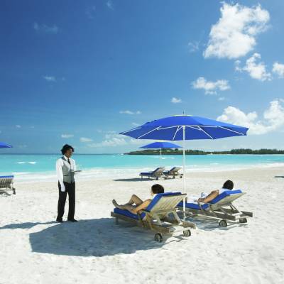a group of people sitting at a beach