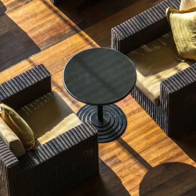 a wooden table topped with a leather chair