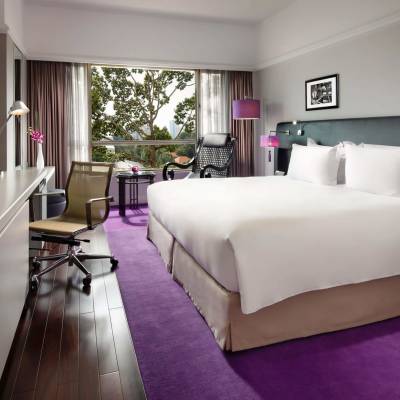 a bedroom with a bed and desk in a room
