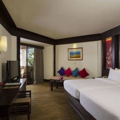 a bedroom with a large bed in a hotel room
