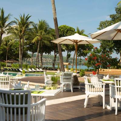 a dining area with palm trees