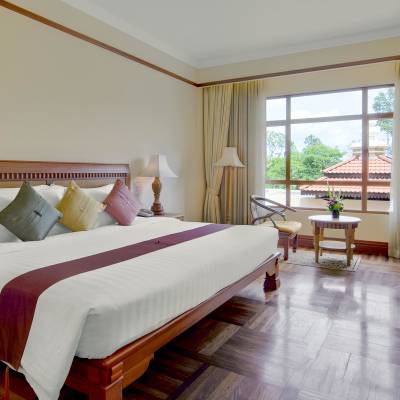 a bedroom with a large bed in a hotel room
