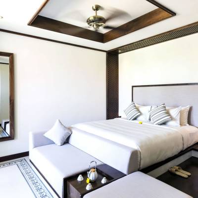 a bedroom with a bed and desk in a room