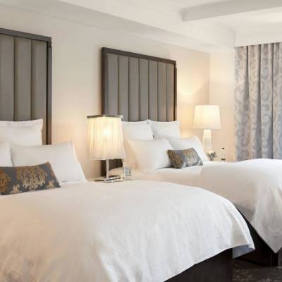 a bedroom with a large bed in a hotel room