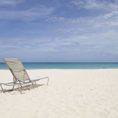 a sandy beach next to a body of water