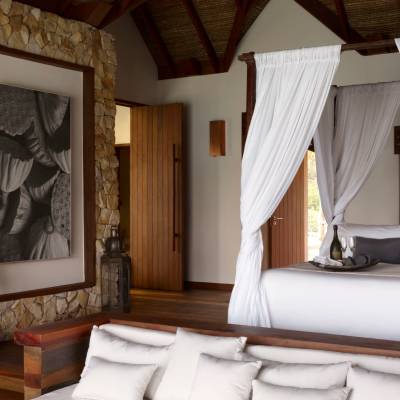 a living room with a bed and a curtain