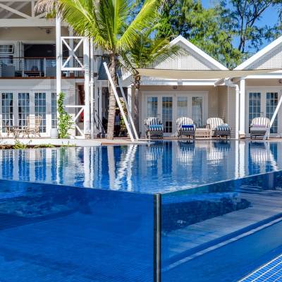 a blue pool of water in front of a house