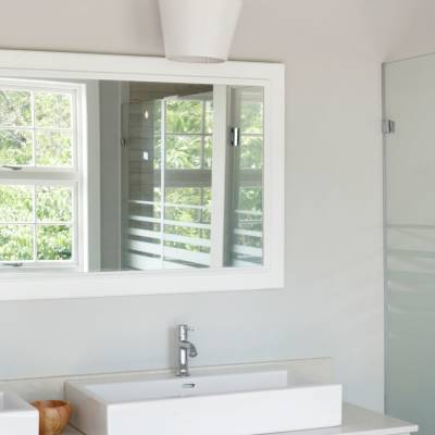 a white sink sitting under a window