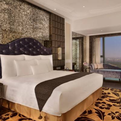 a bedroom with a large bed in a hotel room