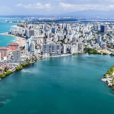 a large body of water with a city in the background