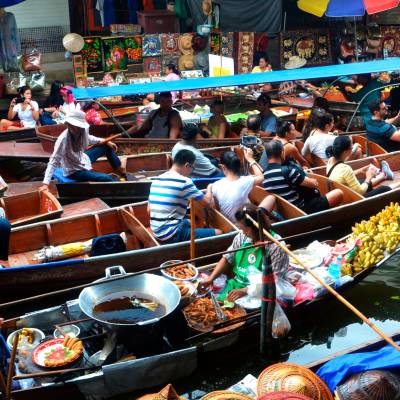 a group of people sitting at a produce market