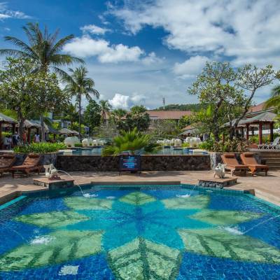 a group of palm trees next to a pool