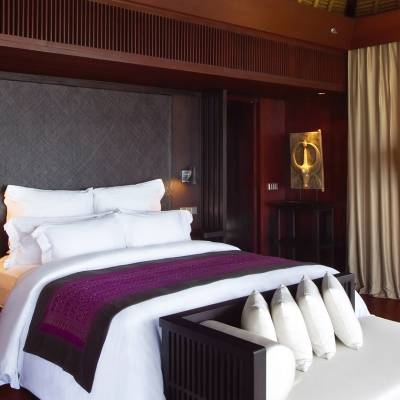 a large white bed in a hotel room