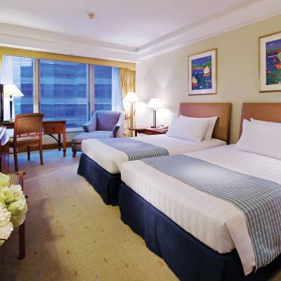 a bedroom with a bed and desk in a room
