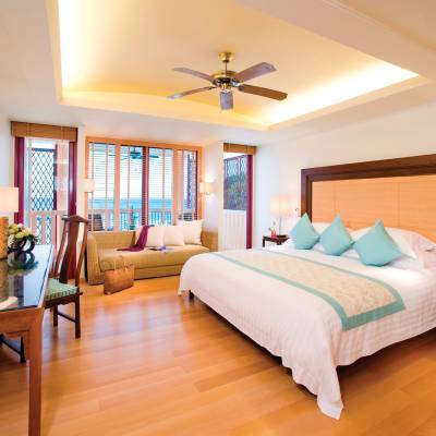 a bedroom with a bed and desk in a room