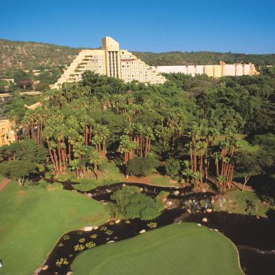 a view of Sun City with tall buildings in a garden