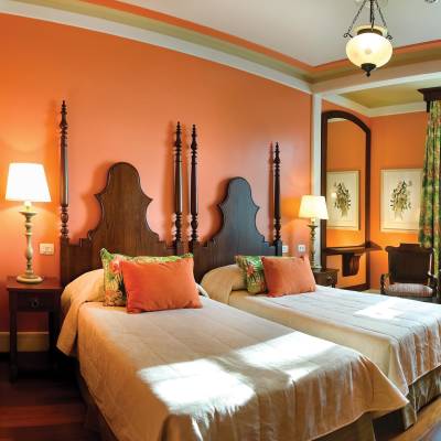 a hotel room with a bed and chair