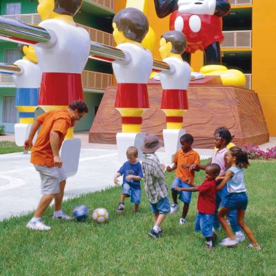 a group of people standing next to a football ball